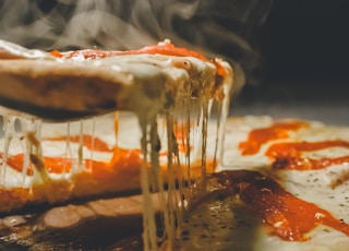 close up photo of pizza with cheese