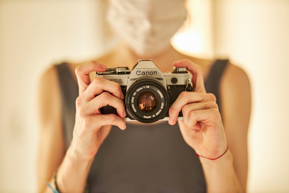 person holding black and silver nikon dslr camera