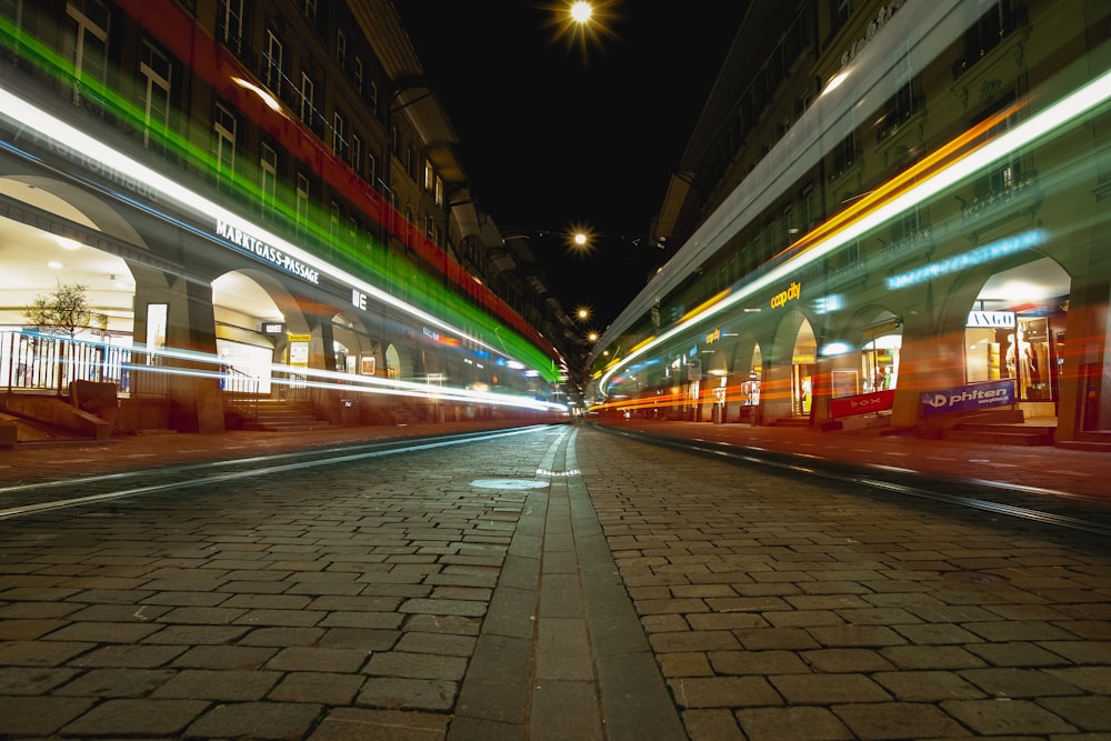 white and green train on the street during night time
