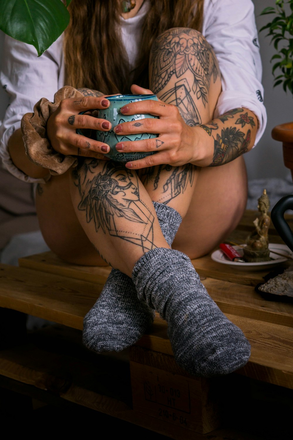 woman in white and black floral shirt with tattoo on her right arm