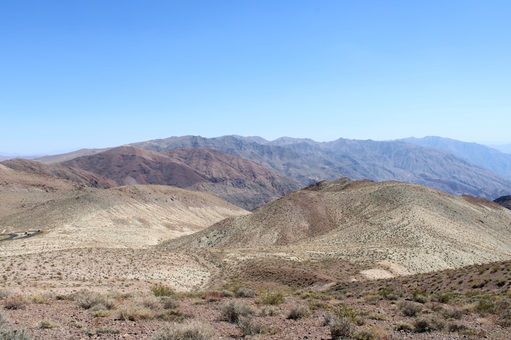 brown and green mountains under blue sky during daytime