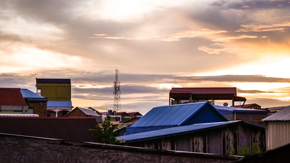 brown and blue houses under cloudy sky during daytime