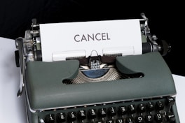 green and white typewriter on black textile