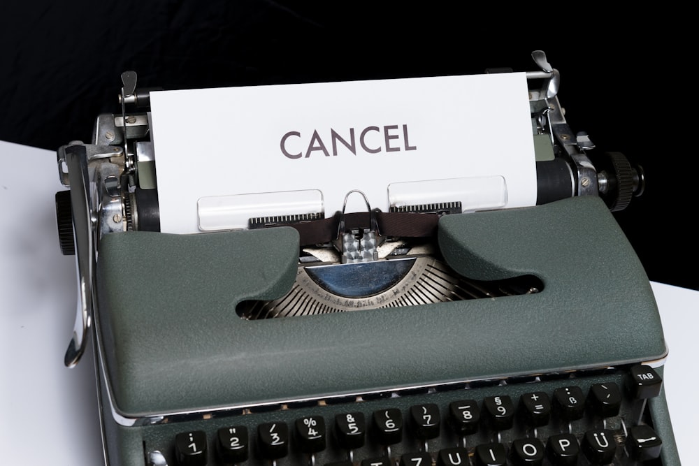 green and white typewriter on black textile