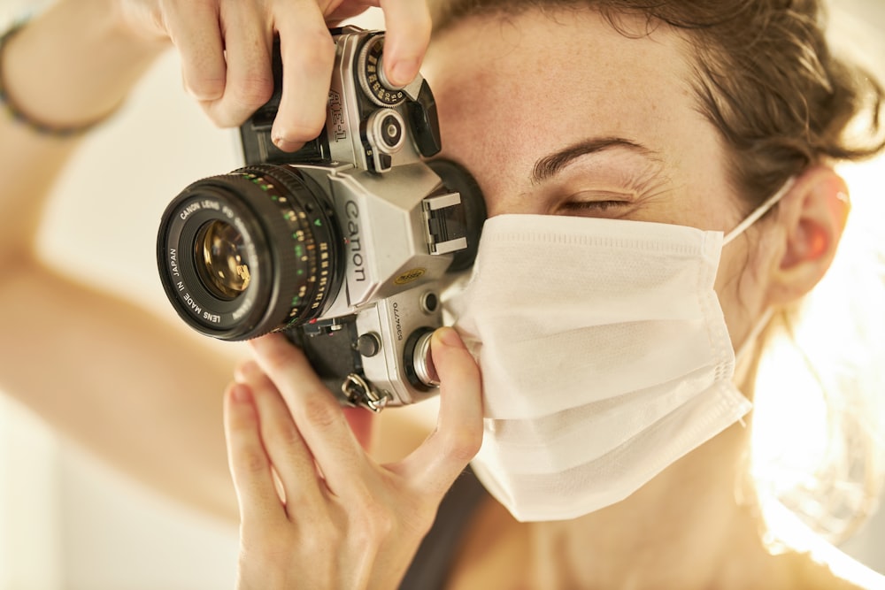 man holding black dslr camera