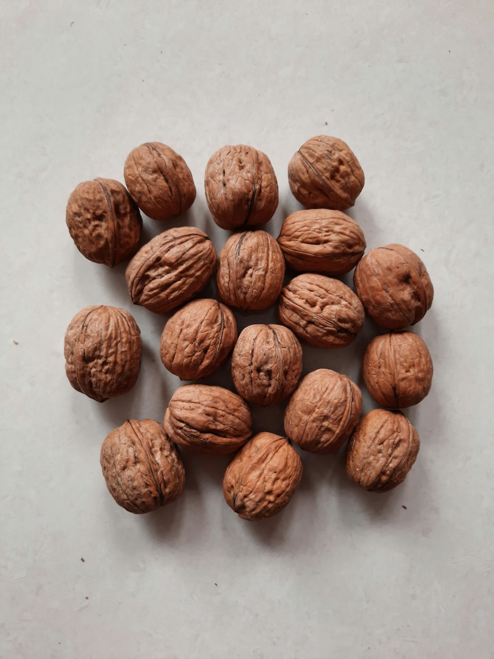 brown round nut on white surface