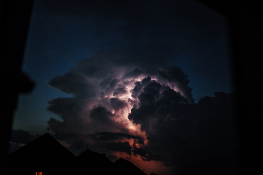 silhouette of mountain under white clouds during daytime