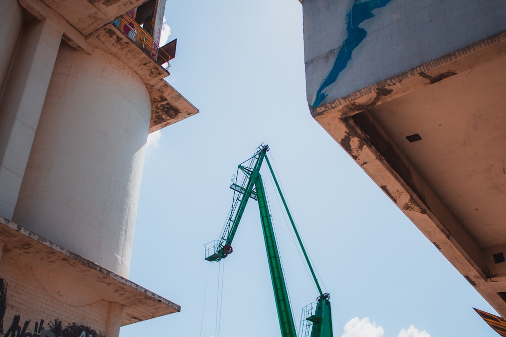 green and yellow crane under blue sky during daytime