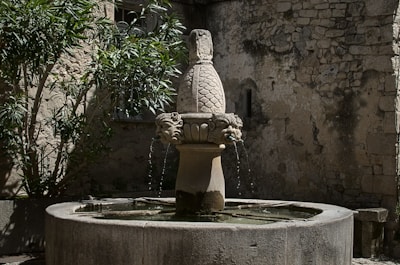 Classic stone fountain with water gently flowing in a courtyard
