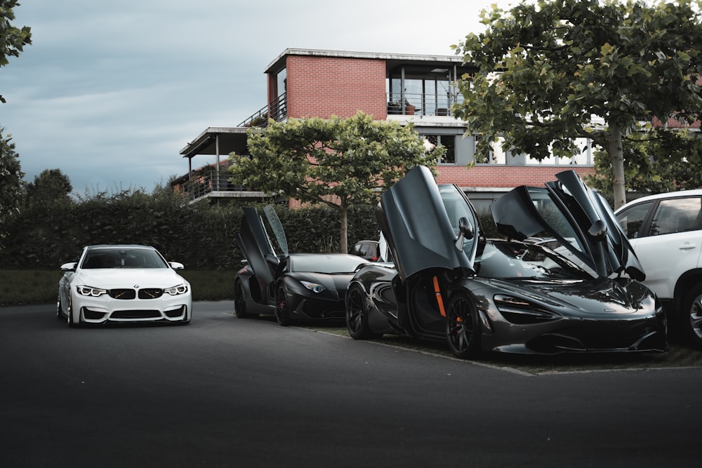 white car parked beside black car