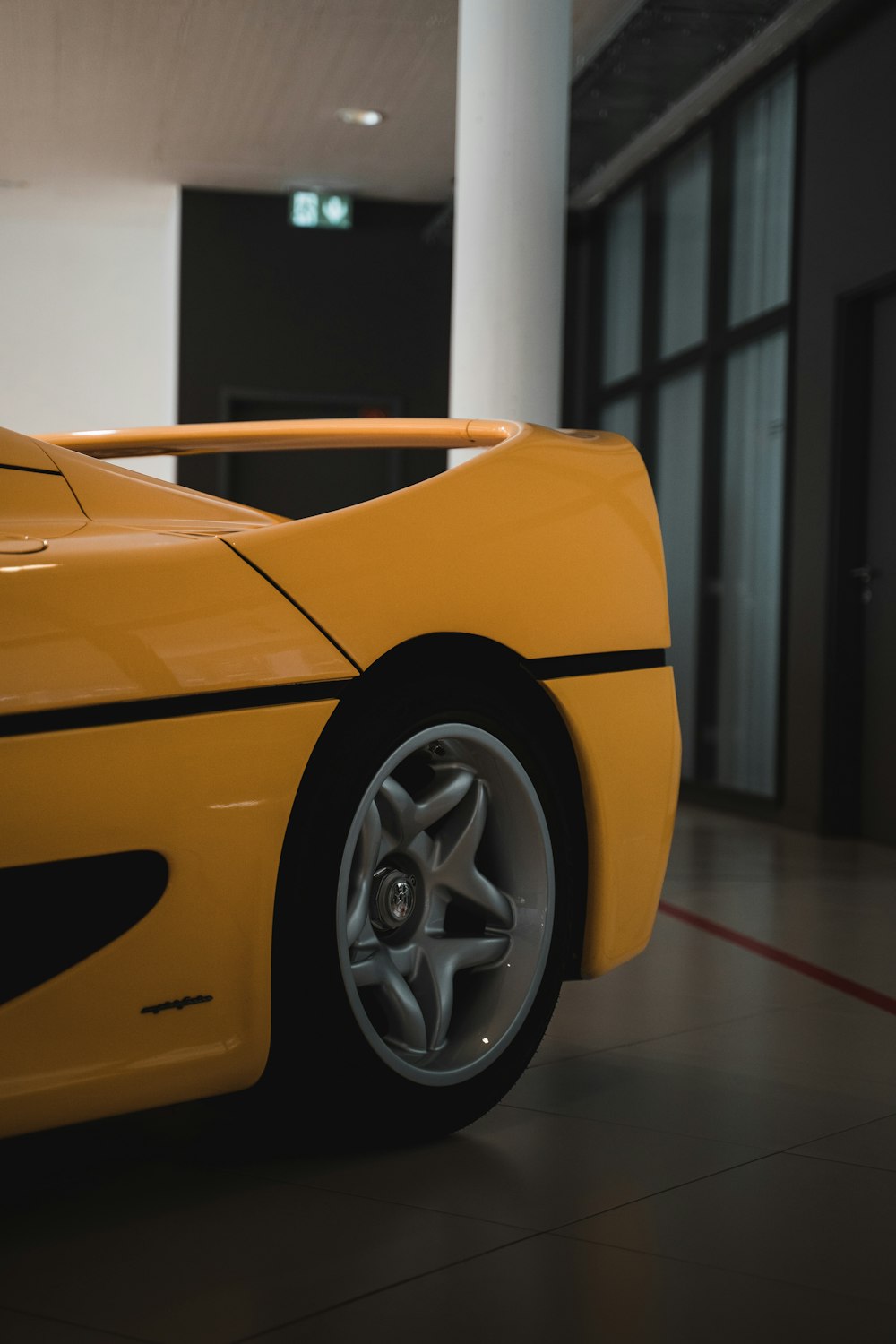 yellow ferrari 458 italia in a room