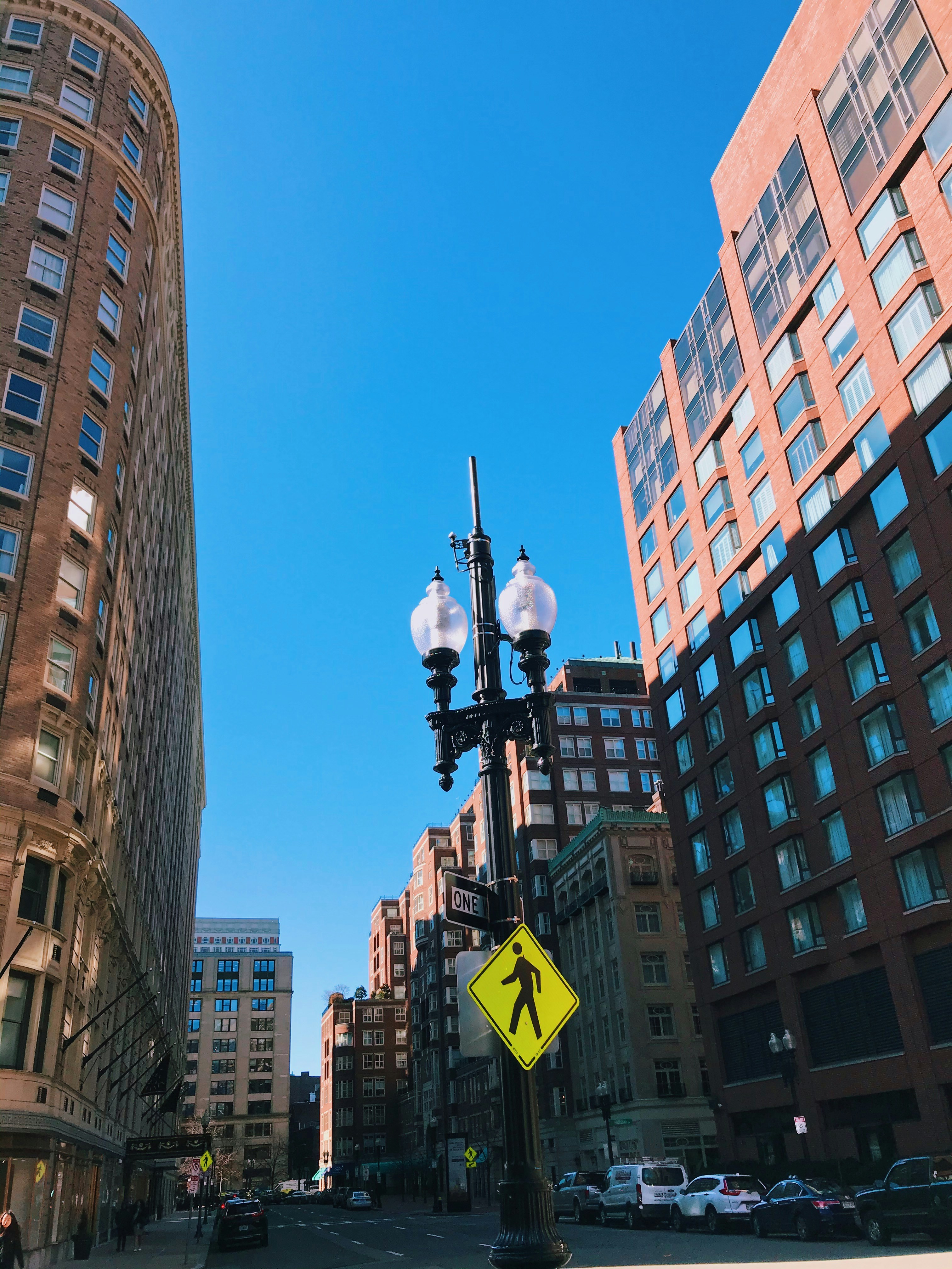 Black street light near high rise buildings during daytime photo Free