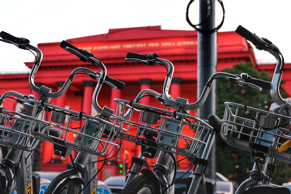 black and gray bicycle on red metal fence