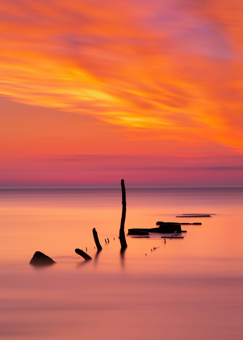 two white boats on sea during sunset