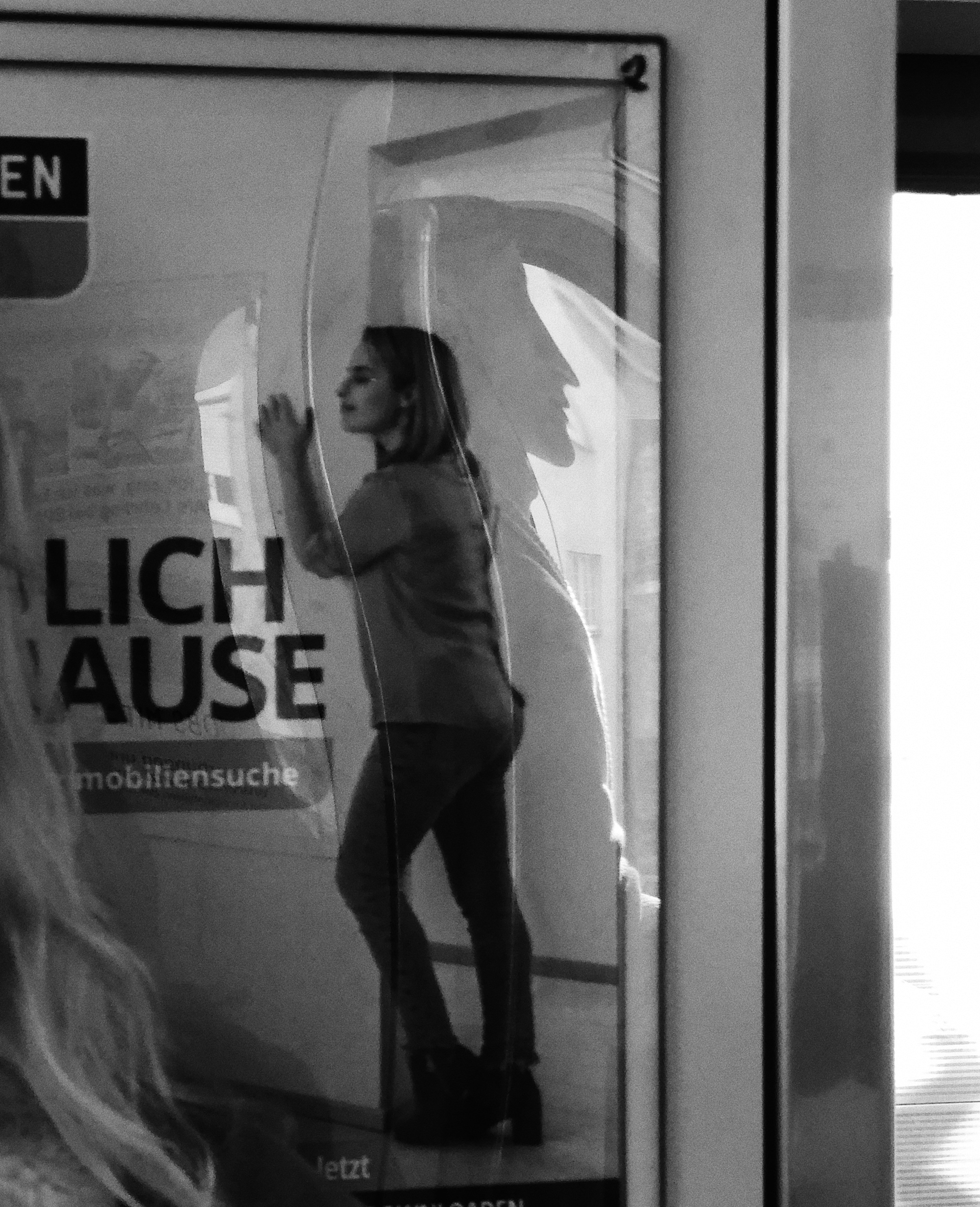 woman in white long sleeve shirt and black pants standing in front of mirror