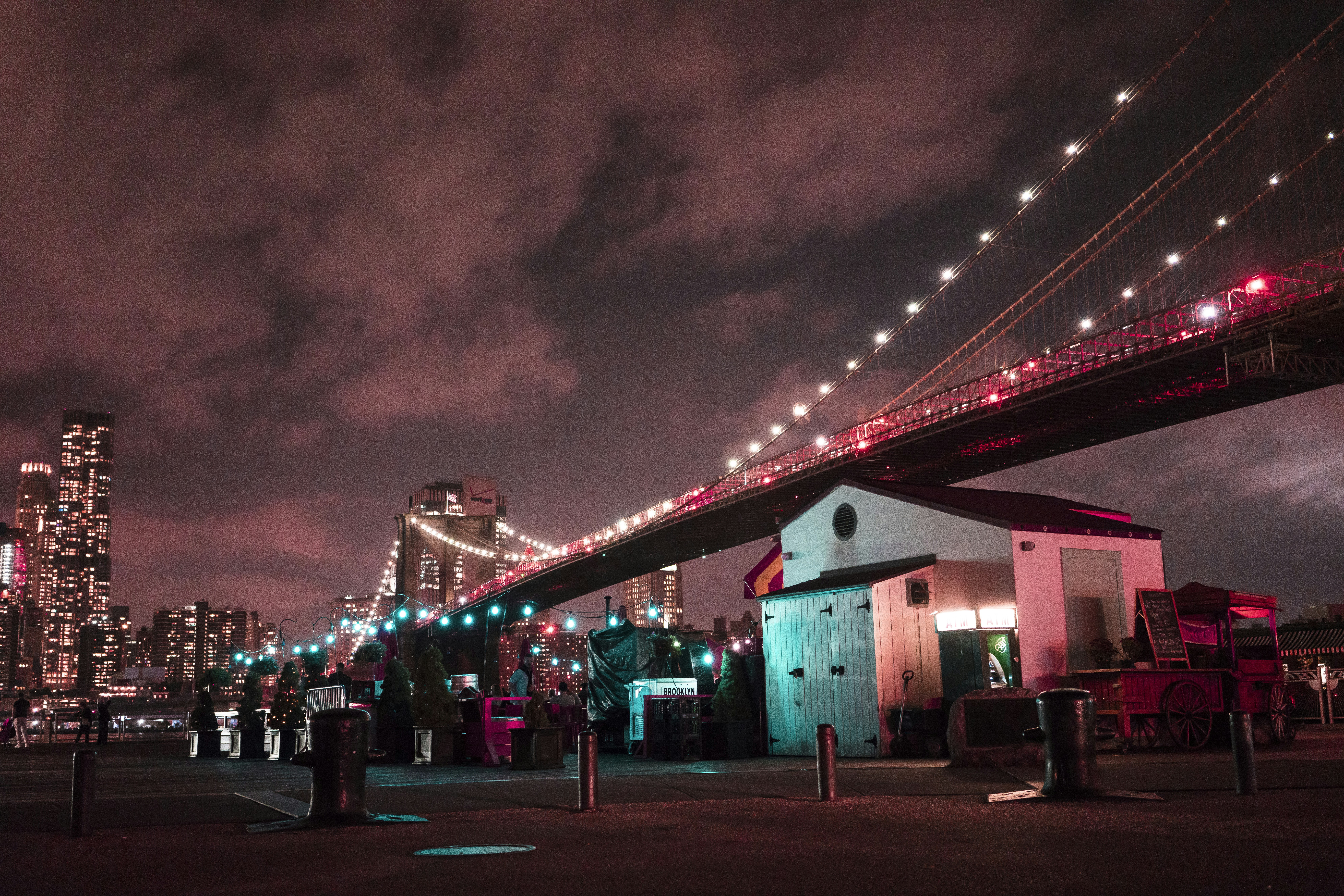 red bridge over the city during night time