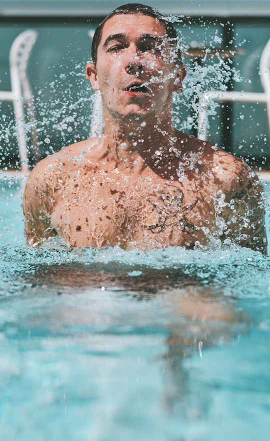 topless man in swimming pool during daytime in Petah Tikva Israel