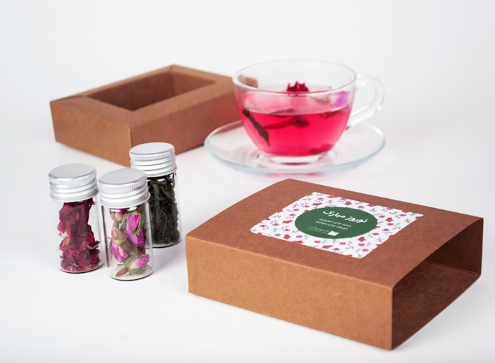 red and brown carton box beside clear glass cup