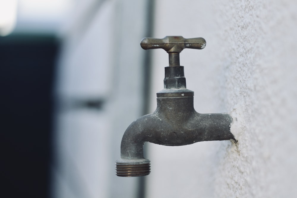 grey metal faucet in close up photography