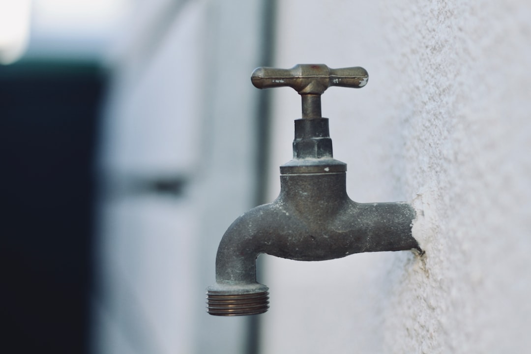  grey metal faucet in close up photography tap