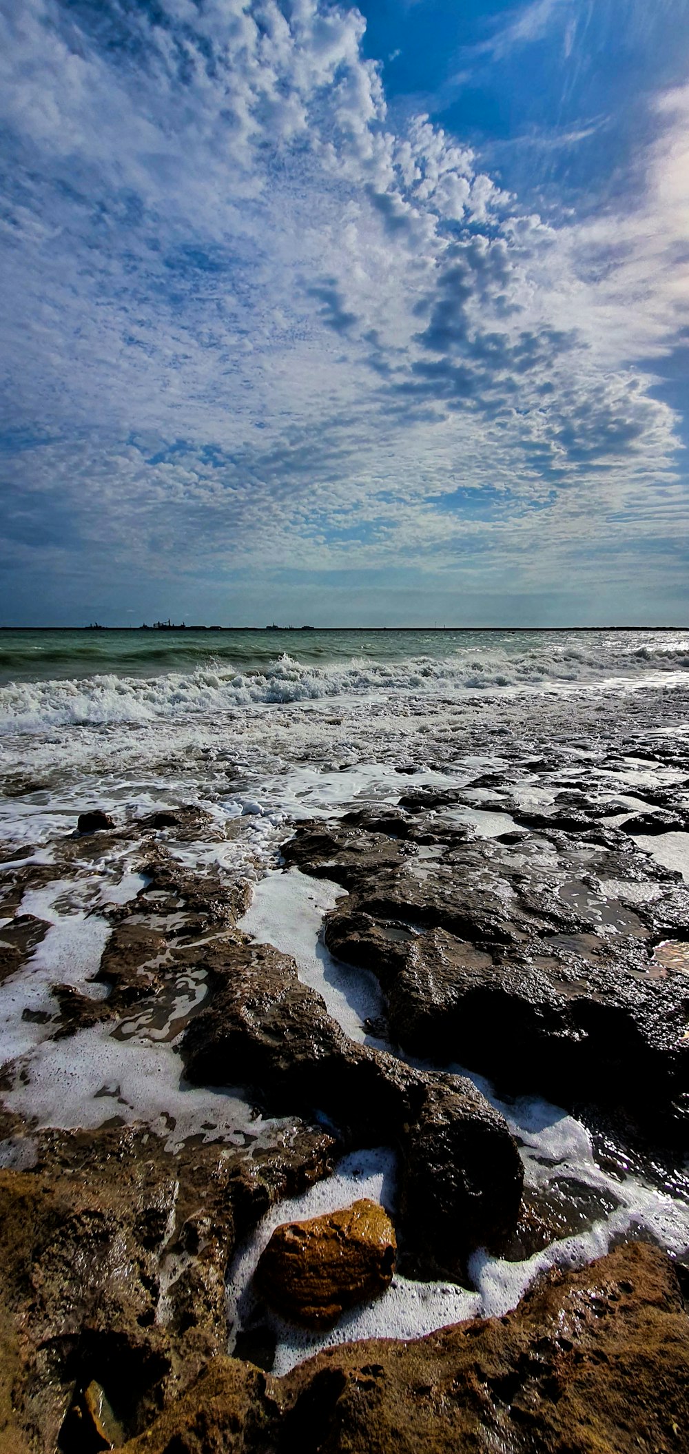 rocky shore under blue sky during daytime