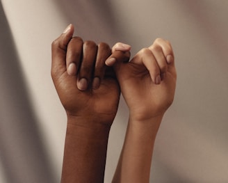 persons hand with white manicure