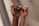 persons hand with white manicure