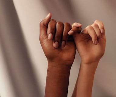 persons hand with white manicure