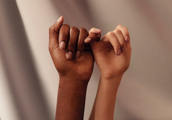 persons hand with white manicure