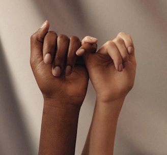 persons hand with white manicure