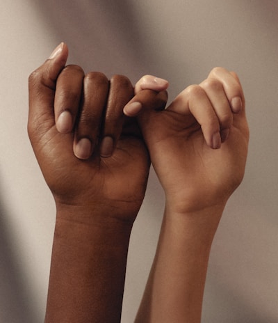 persons hand with white manicure