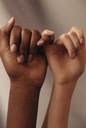 persons hand with white manicure