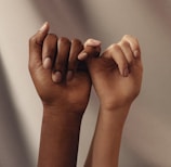 persons hand with white manicure