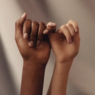 persons hand with white manicure