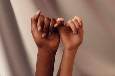 persons hand with white manicure friendship google meet background