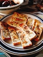 sliced pizza on blue and white ceramic plate