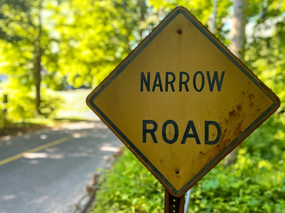 a yellow road sign sitting on the side of a road