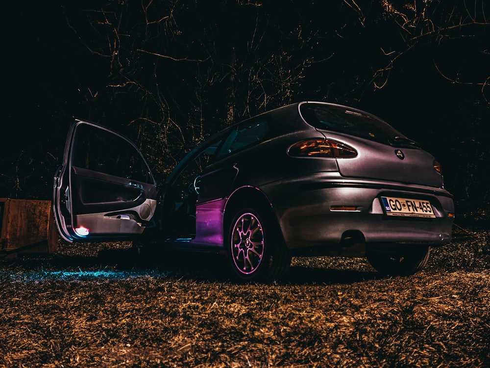 purple honda car on brown field during night time