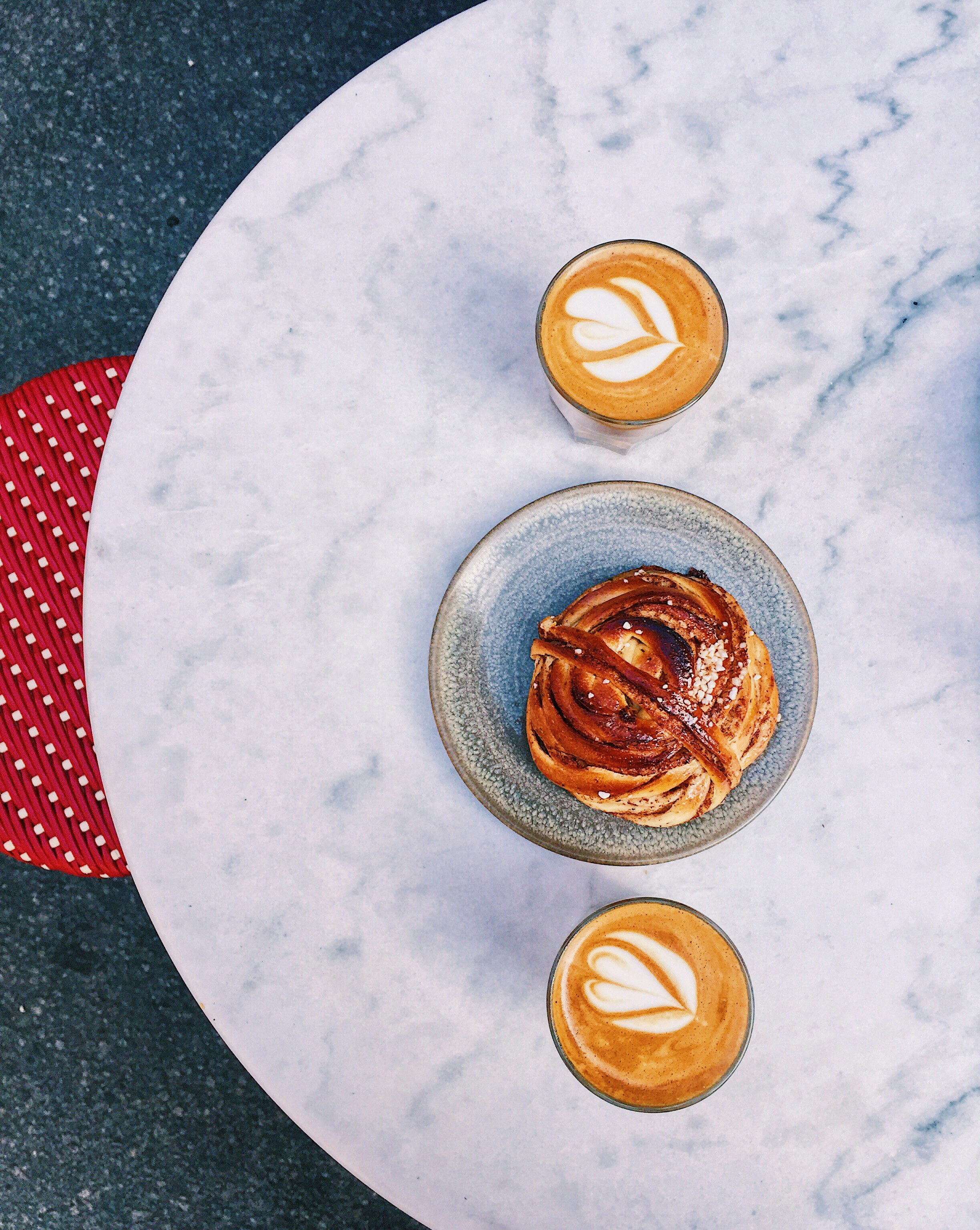 Fica time with cortado coffee and a cinnamon bun at Café & Bageri Pascal in Södermalm, Sotckholm. June 2019.