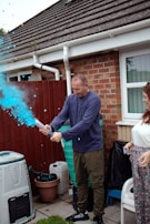 Bright orange foam cannon set up ready to spray at a festive outdoor event.