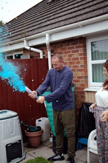 Bright orange foam cannon set up ready to spray at a festive outdoor event.