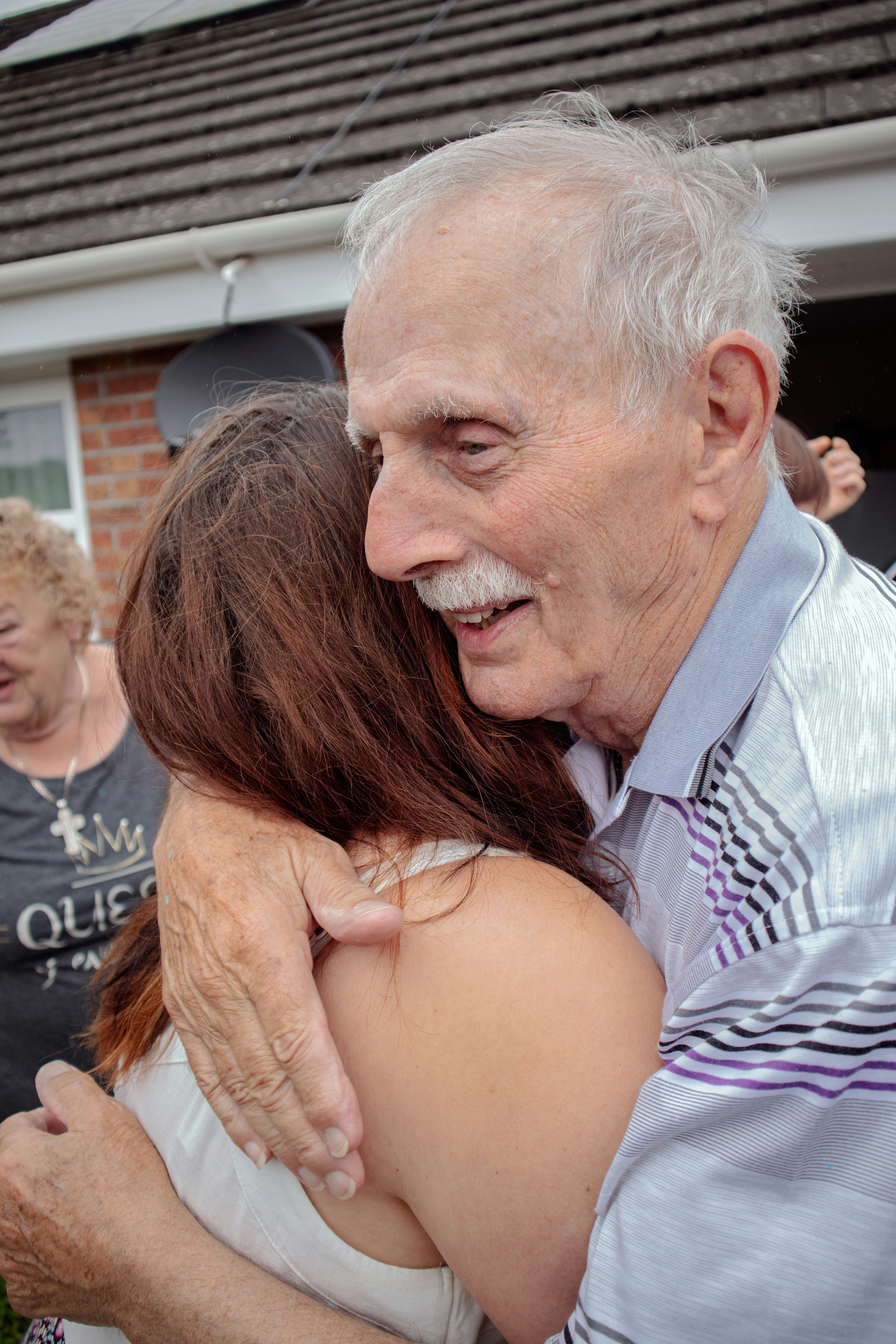 Grandparent hugging grandchild with love