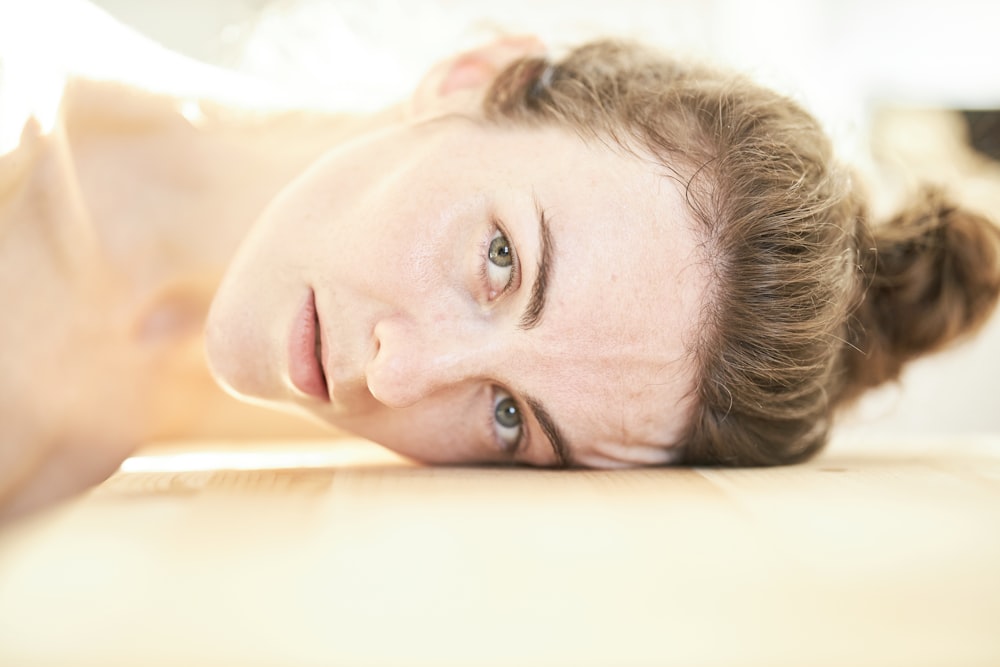 woman lying on white bed