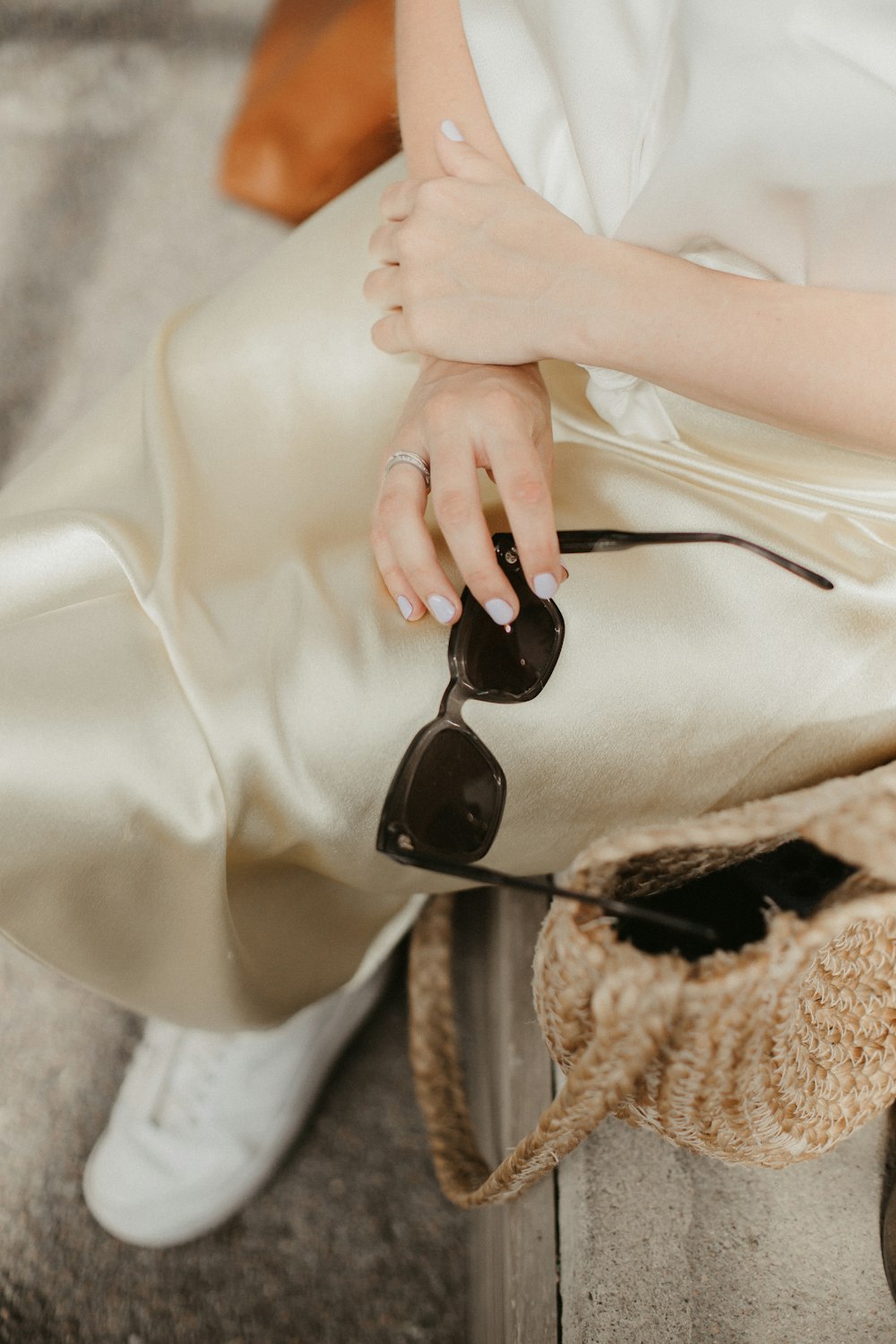 woman in white dress wearing black sunglasses