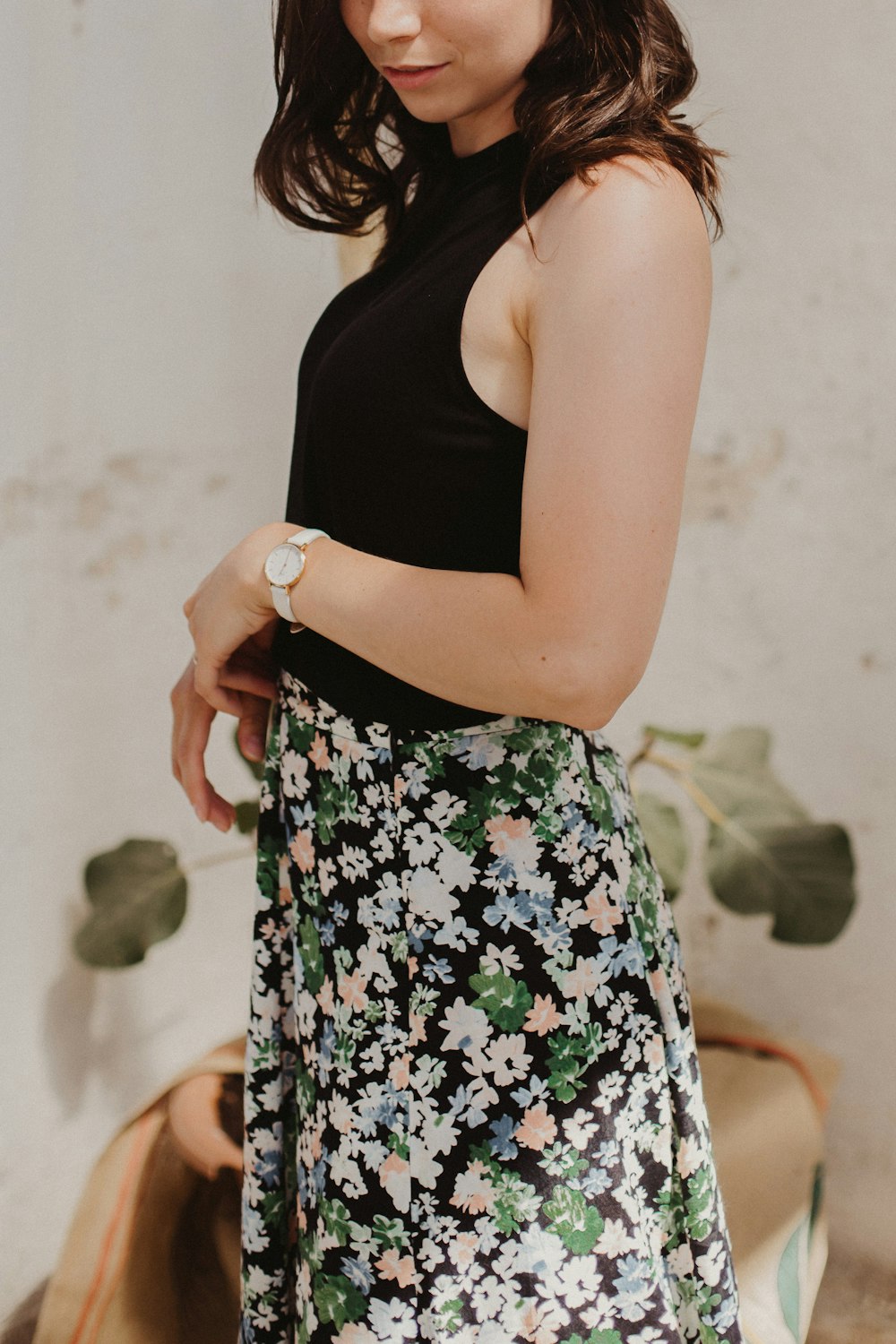 woman in black tank top and white black and red floral skirt