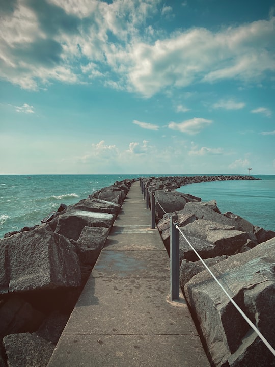 brown wooden dock on sea under blue sky during daytime in Lake Erie United States