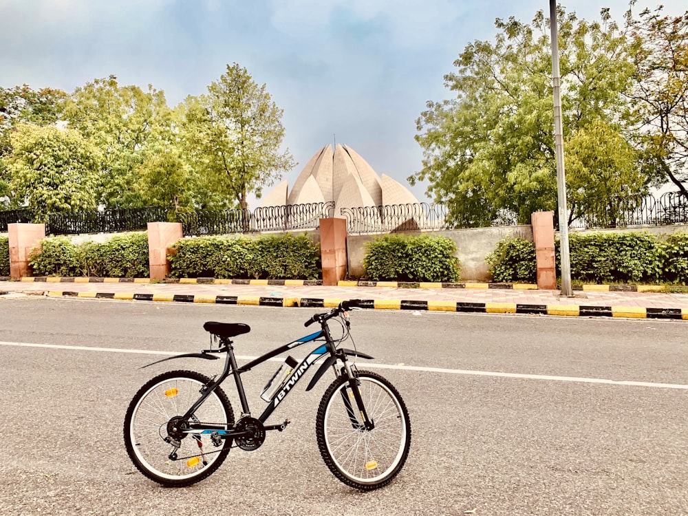 black and gray mountain bike on gray concrete road during daytime