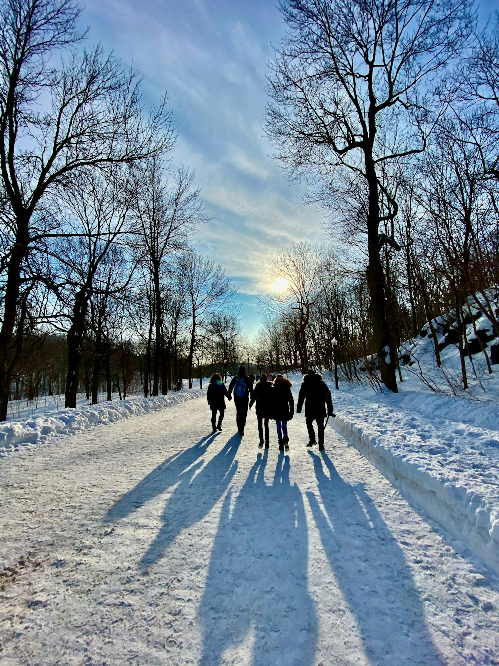 people walking on snow covered road during daytime