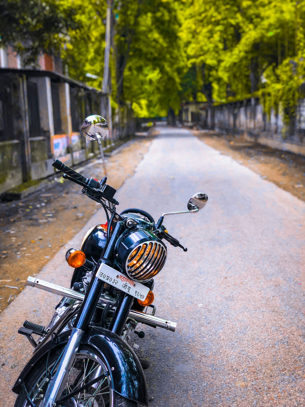 black motorcycle parked on gray concrete road during daytime