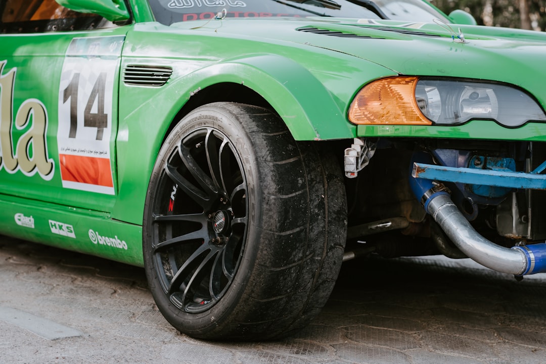 green and black car on gray concrete road